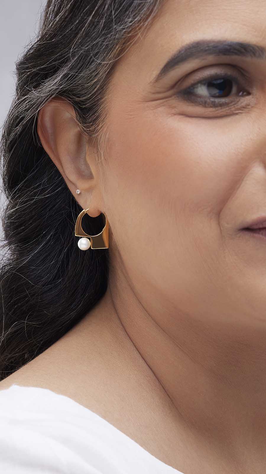 Zoomed picture of an indian working woman wearing patience earrings