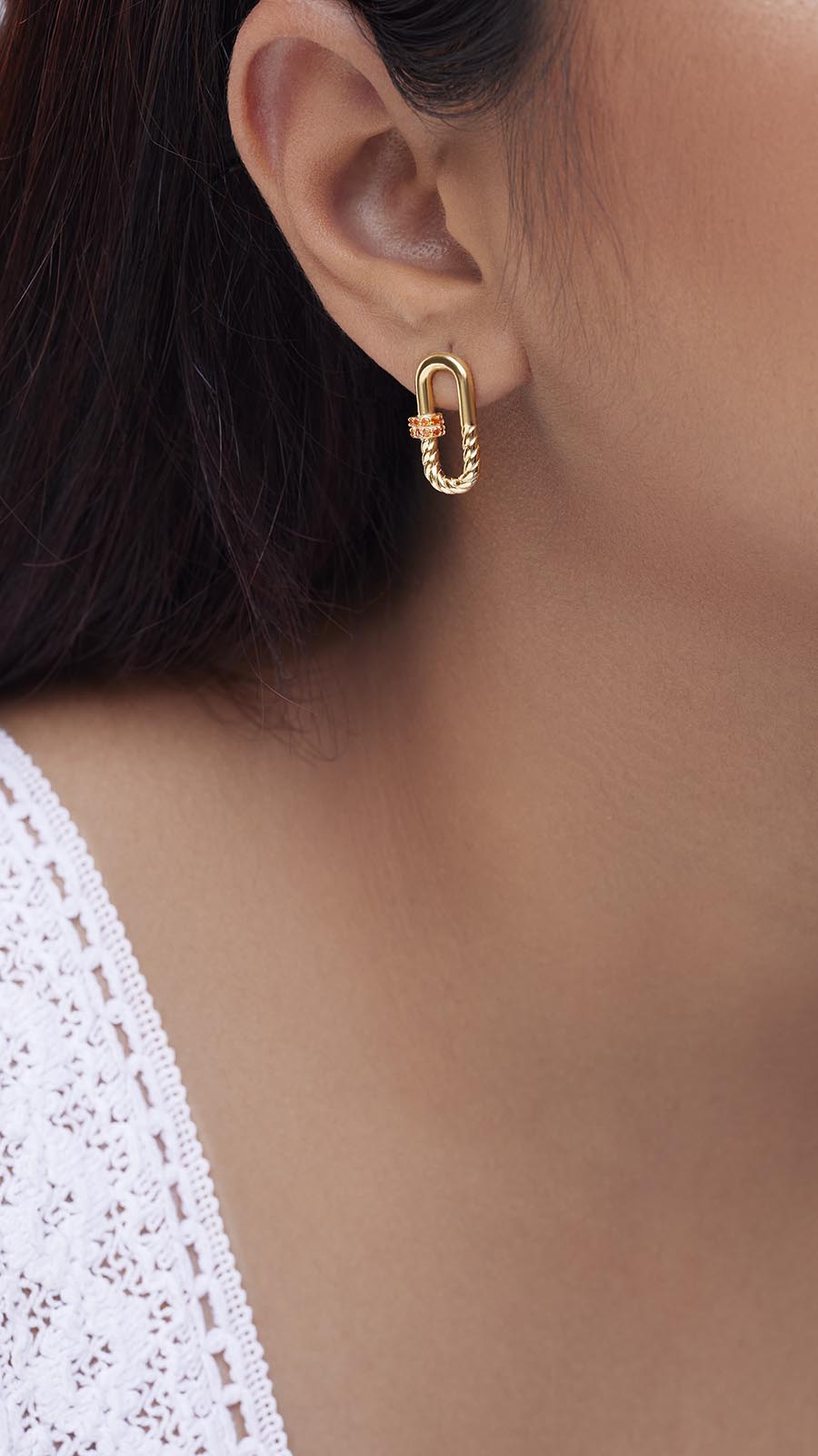 Zoomed picture of an Indian working woman wearing strength earrings