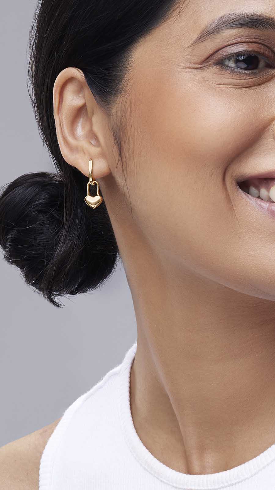 Zoomed picture of an Indian working woman wearing self love earrings